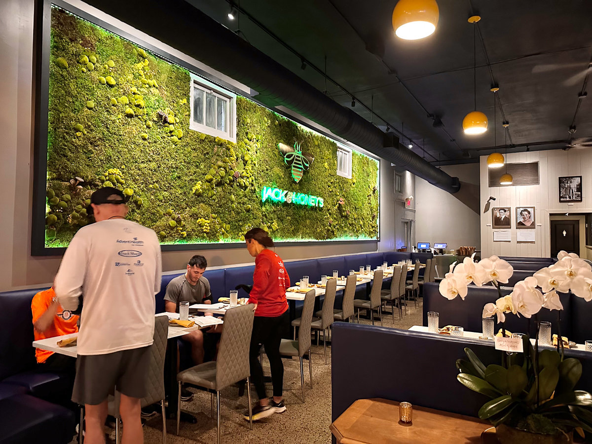greenery wall with tables and chairs
